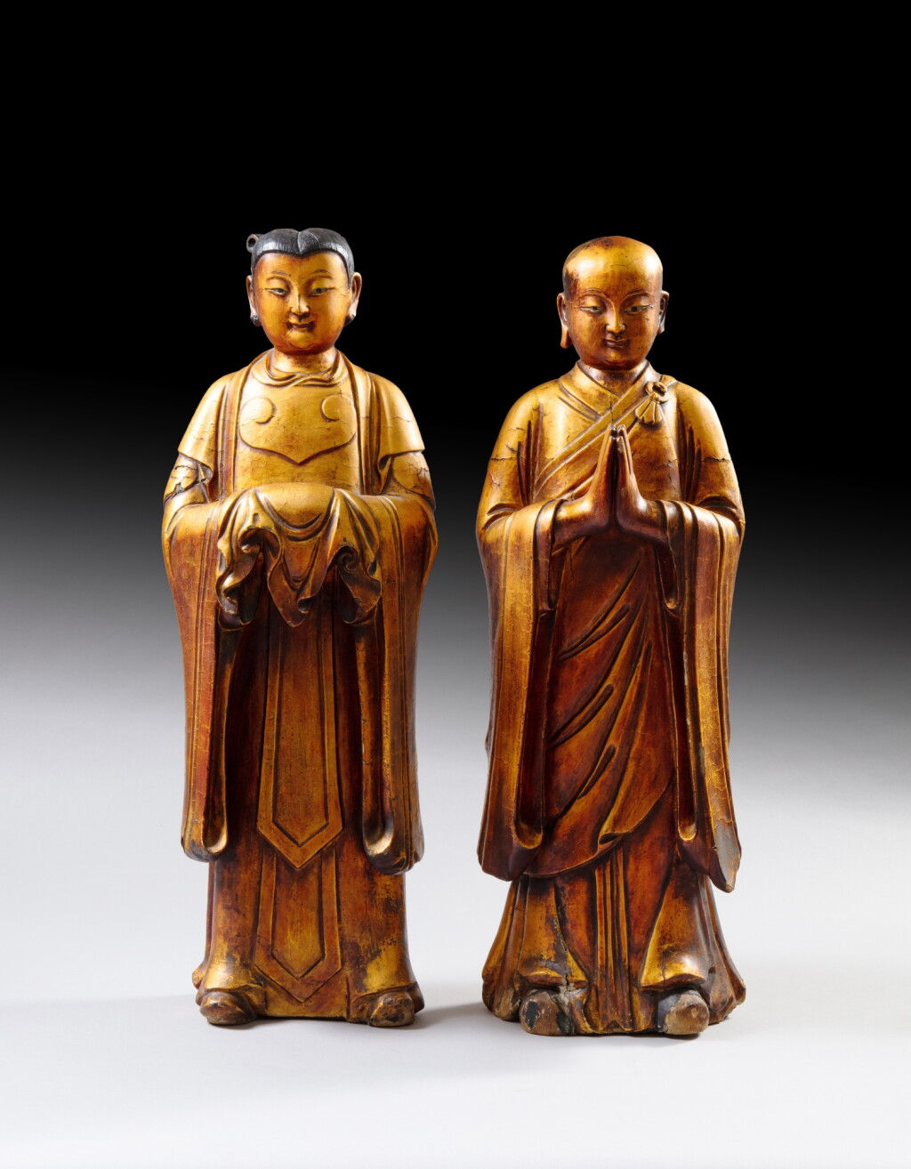 View full screen - View 1 of Lot 53. Two large lacquer-gilt wood standing figures of attendants, Qing dynasty, 17th - 18th century | 清十七至十八世紀 漆金木雕神仙立像一組兩尊.