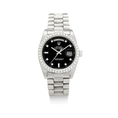 View full screen - View 1 of Lot 1107. ROLEX | DAY-DATE, REFERENCE 1803, A WHITE GOLD AND DIAMOND-SET WRISTWATCH WITH DAY, DATE, BRACELET AND LATER RODIUM-PLATED BEZEL, CIRCA 1982.