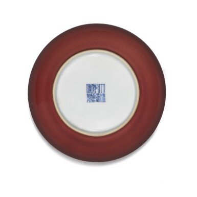 View full screen - View 1 of Lot 142. A copper-red saucer dish Seal mark and period of Qianlong | 清乾隆 紅釉盤 《大清乾隆年製》款.