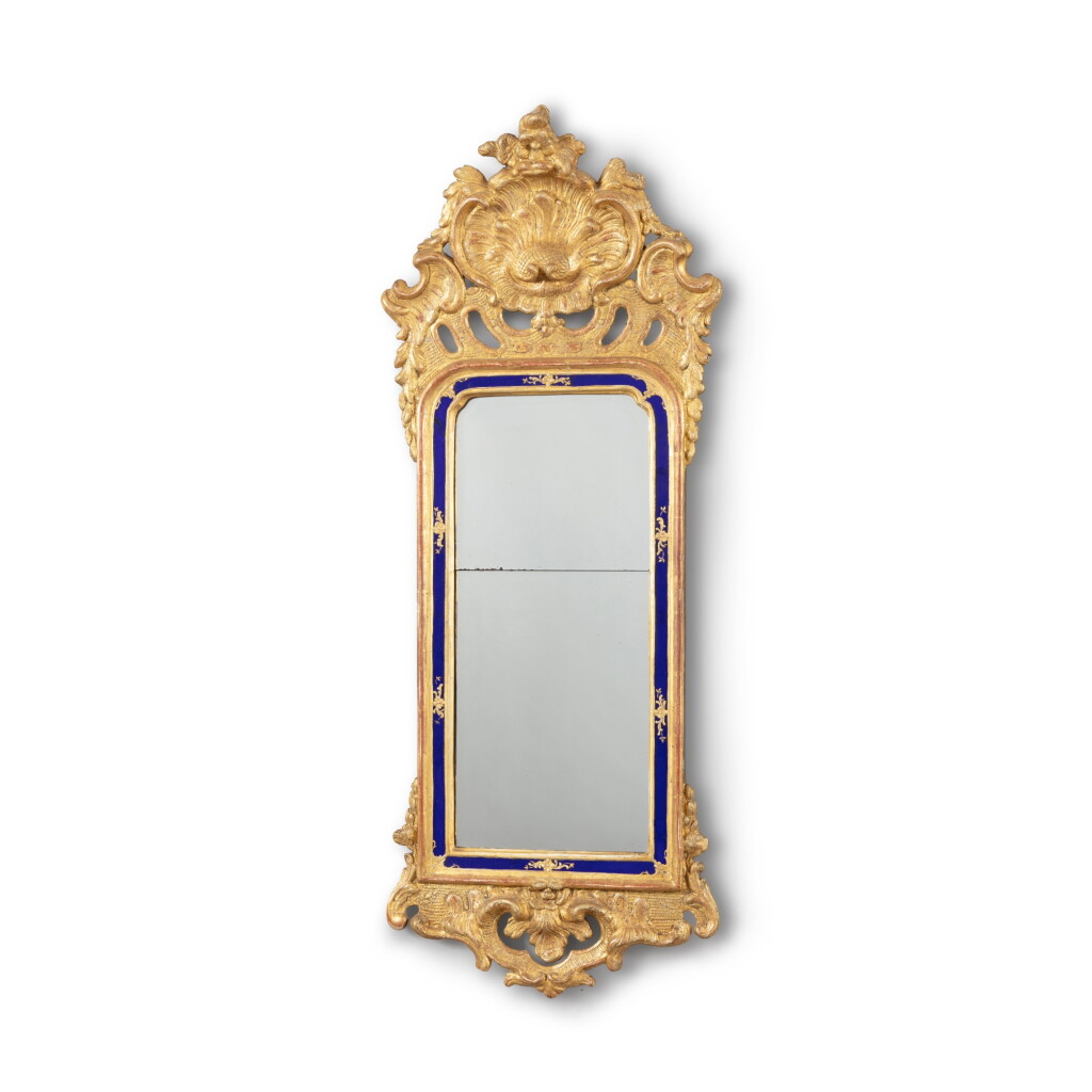 View full screen - View 1 of Lot 117. A Swedish carved gilt and gesso mirror, circa 1760 | Miroir en bois doré, travail suédois, vers 1760.