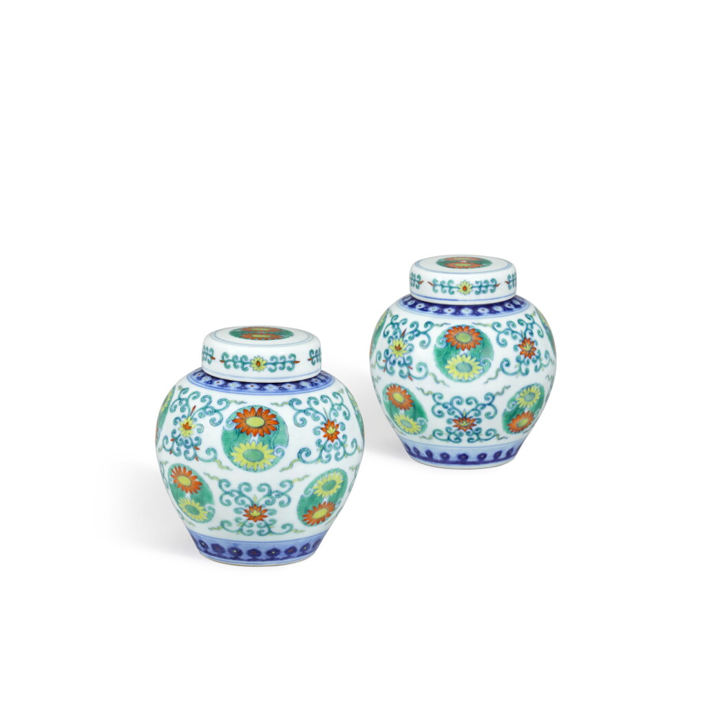 View full screen - View 1 of Lot 143. A fine and very rare pair of doucai 'lotus and chrysanthemum' jars and covers, Seal marks and period of Qianlong | 清乾隆 鬪彩番蓮團菊紋蓋罐一對 《大清乾隆年製》款.