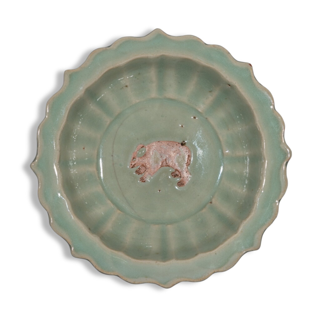 View full screen - View 1 of Lot 2. An exceedingly rare biscuit-reserved barbed-rim 'Longquan' celadon-glazed 'bear' dish, Yuan dynasty, Yanyou reign, corresponding to 1314-1320.