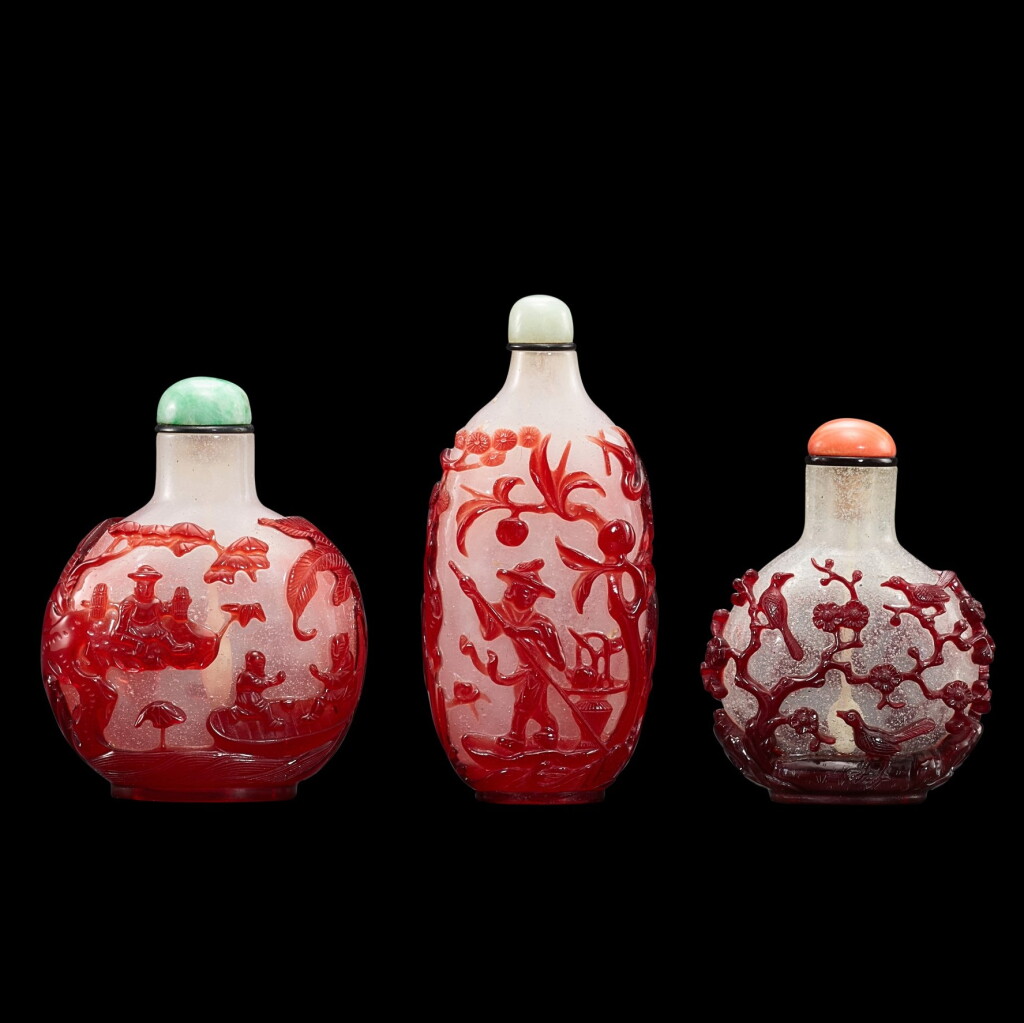 View full screen - View 1 of Lot 1057. Three red overlay glass snuff bottles, Qing dynasty, 18th - 19th century | 清十八至十九世紀 珍珠地套紅料鼻煙壺一組三件.