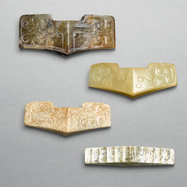 View full screen - View 1 of Lot 748. Three jade 'mask' sword guards and one 'groove' sword guard, Eastern Zhou dynasty, late Warring States period - Han dynasty | 東周戰國晚期至漢 獸面玉劍鐔三件 及 瓦溝紋玉劍鐔一件.