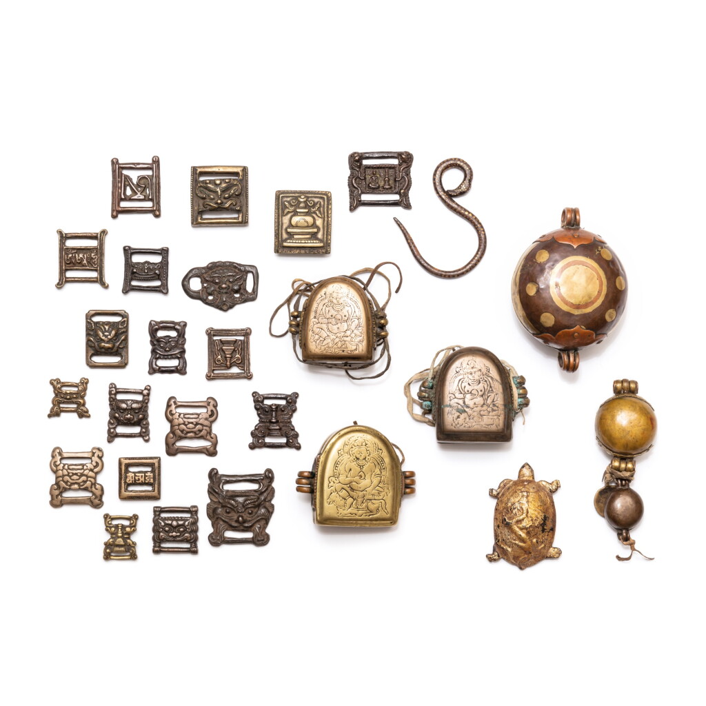 View full screen - View 1 of Lot 50. A study collection of 'Gau' reliquary boxes and buckles, Tibet and other Himalayan regions, 11th/17th century | 西藏及喜馬拉雅其他地區 十一至十七世紀 嘎烏盒及帶扣一組二十六件.