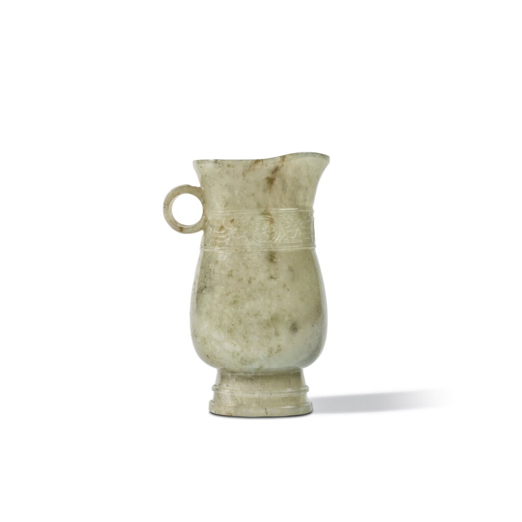 View full screen - View 1 of Lot 640. An archaistic pale celadon jade ewer, Qing dynasty, 19th century | 清十九世紀 青白玉雕仿古觥.