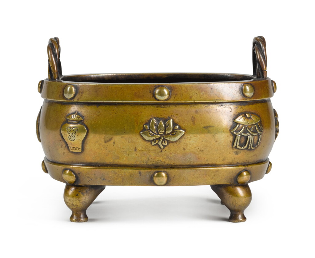 View full screen - View 1 of Lot 25. A RECTANGULAR BRONZE 'BAJIXIANG' CENSER | LATE MING DYNASTY | 晚明 雙繩耳八吉祥紋四方銅爐 .