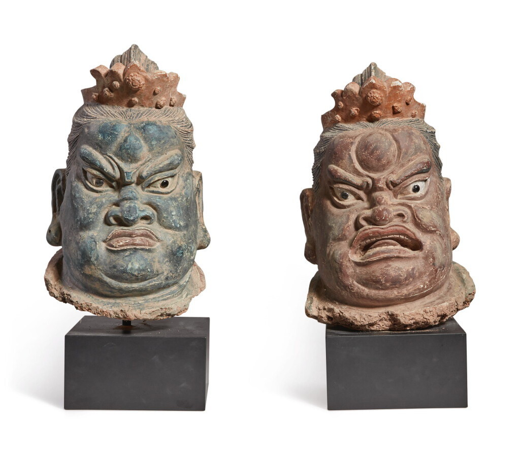 View full screen - View 1 of Lot 1107. A LARGE PAIR OF POLYCHROMED STUCCO HEADS OF BUDDHIST GUARDIANS, YUAN / MING DYNASTY.
