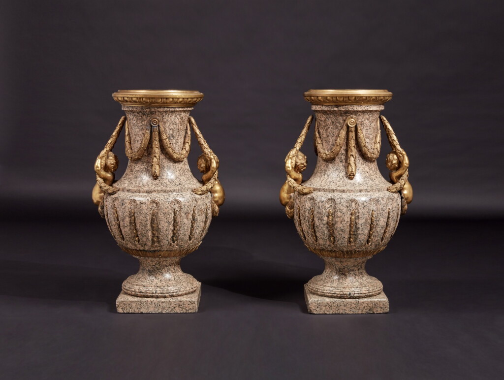 View full screen - View 1 of Lot 57. A Monumental Pair of Gilt Bronze-Mounted Pink Granite Vases, the Mounts Circa 1840 After Designs by Jean-Louis Prieur or Jean-François Forty; the Vases Possibly Late 18th Century.