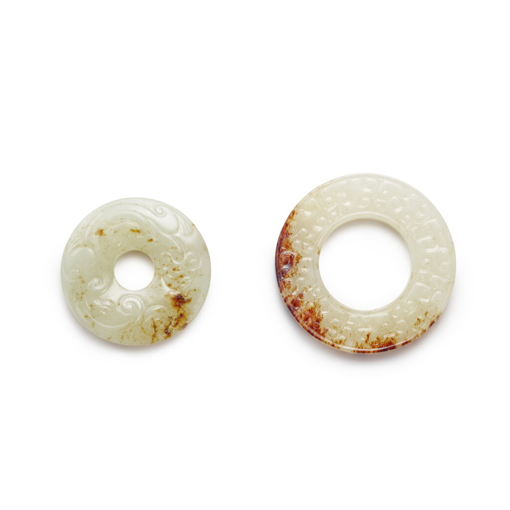View full screen - View 1 of Lot 147. A celadon jade 'chilong' bi disc and a white jade bi disc, 19th / 20th century.