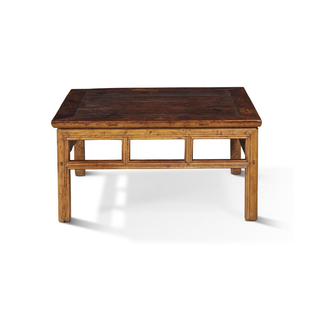 View full screen - View 1 of Lot 41. A 'huanghuali' and 'nanmu' low square table, Qing dynasty, 18th century with later modifications.