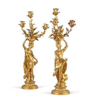 View full screen - View 1 of Lot 53. A pair of late Louis XVI gilt bronze three-light figural candelabra | Paire de candélabres à trois lumières en bronze doré de la fin de l'époque Louis XVI.