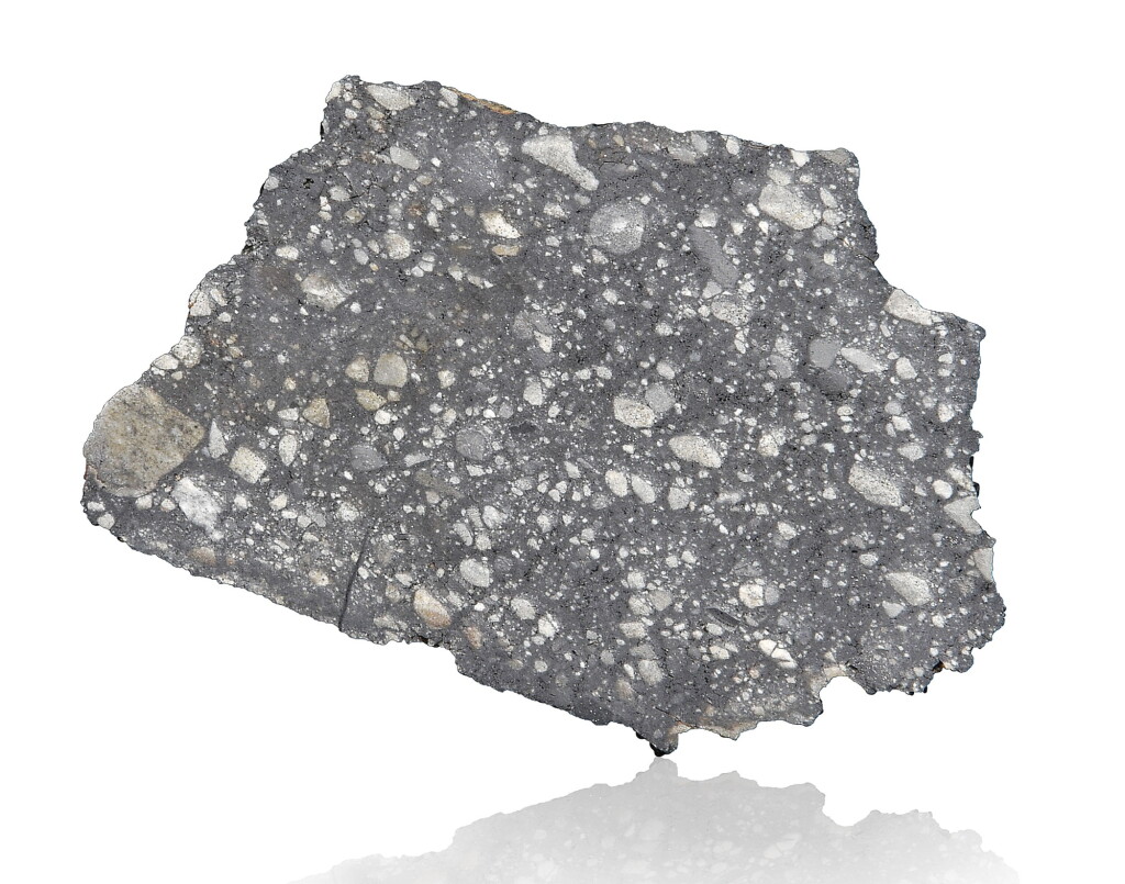 View full screen - View 1 of Lot 107. NOTABLE OFFERING OF A LUNAR METEORITE — END PIECE OF THE QUINTESSENTIAL LUNAR BRECIA, NWA 12691.