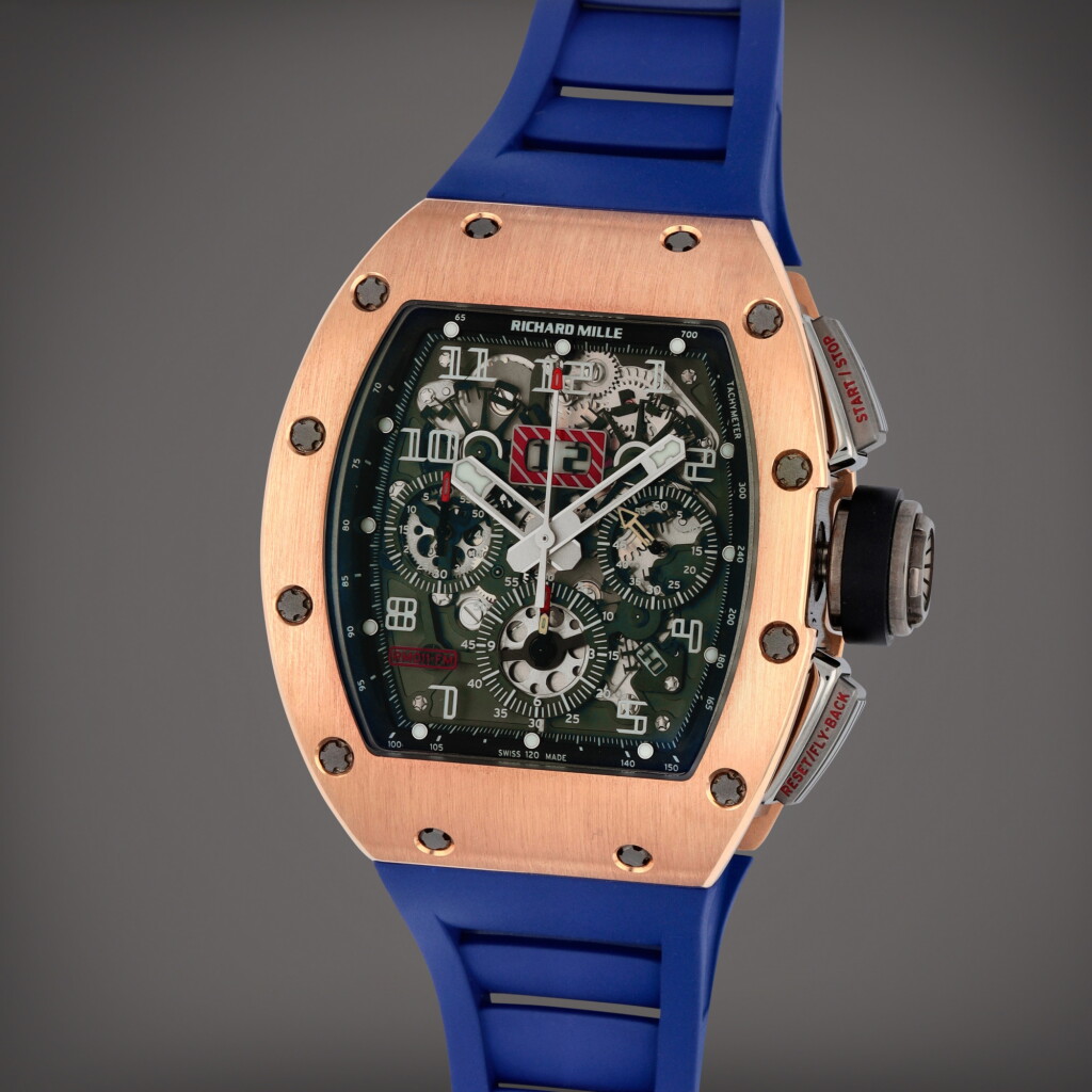 View full screen - View 1 of Lot 34. 'Felippe Massa', Reference RM011 A pink gold and titanium open-work annual calendar flyback chronograph wristwatch with digital date diplay Circa 2010.