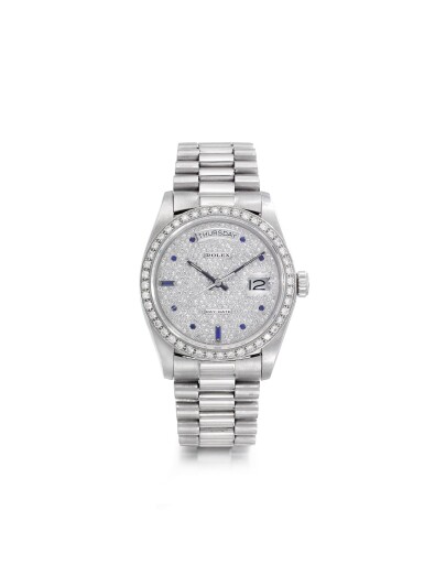 View full screen - View 1 of Lot 97. ROLEX | REFERENCE 18026/18000 DAY-DATE A PLATINUM, DIAMOND AND SAPPHIRE-SET AUTOMATIC WRISTWATCH WITH DAY, DATE, AND BRACELET, CIRCA 1986.