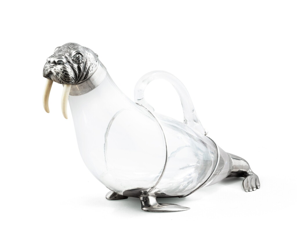 View full screen - View 1 of Lot 2. An Italian glass silver-mounted decanter shaped as a walrus, with ivory tusks, Buccellati, Milan, circa 1980 | Caraffe en verre montée en argent en forme de morse, les défenses en ivoire par Buccellati, Milan, vers 1980.