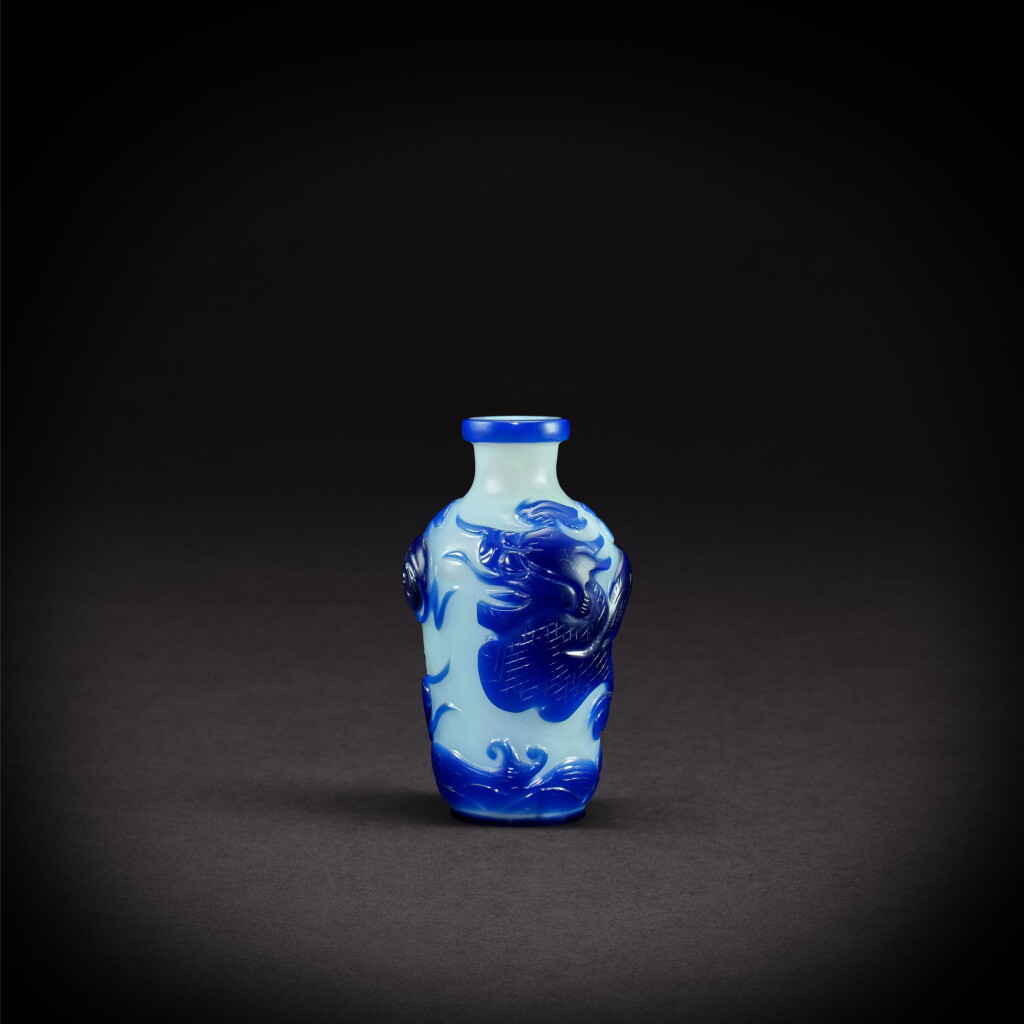 View full screen - View 1 of Lot 3410. A small blue-overlaid white glass 'dragon' vase, Mark and period of Qianlong | 清乾隆 白地套藍料龍紋小瓶 《乾隆年製》款.