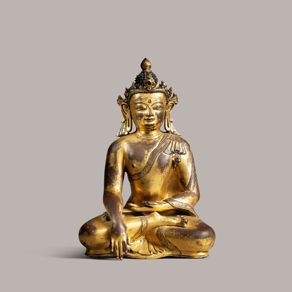 View full screen - View 1 of Lot 332. Gilt copper Buddha Shakyamuni with inset stones Nepal, Early Malla Period (c. 1200-1482) 14th/15th century | 尼泊爾 十四/十五世紀 鎏銅合金佛坐像.