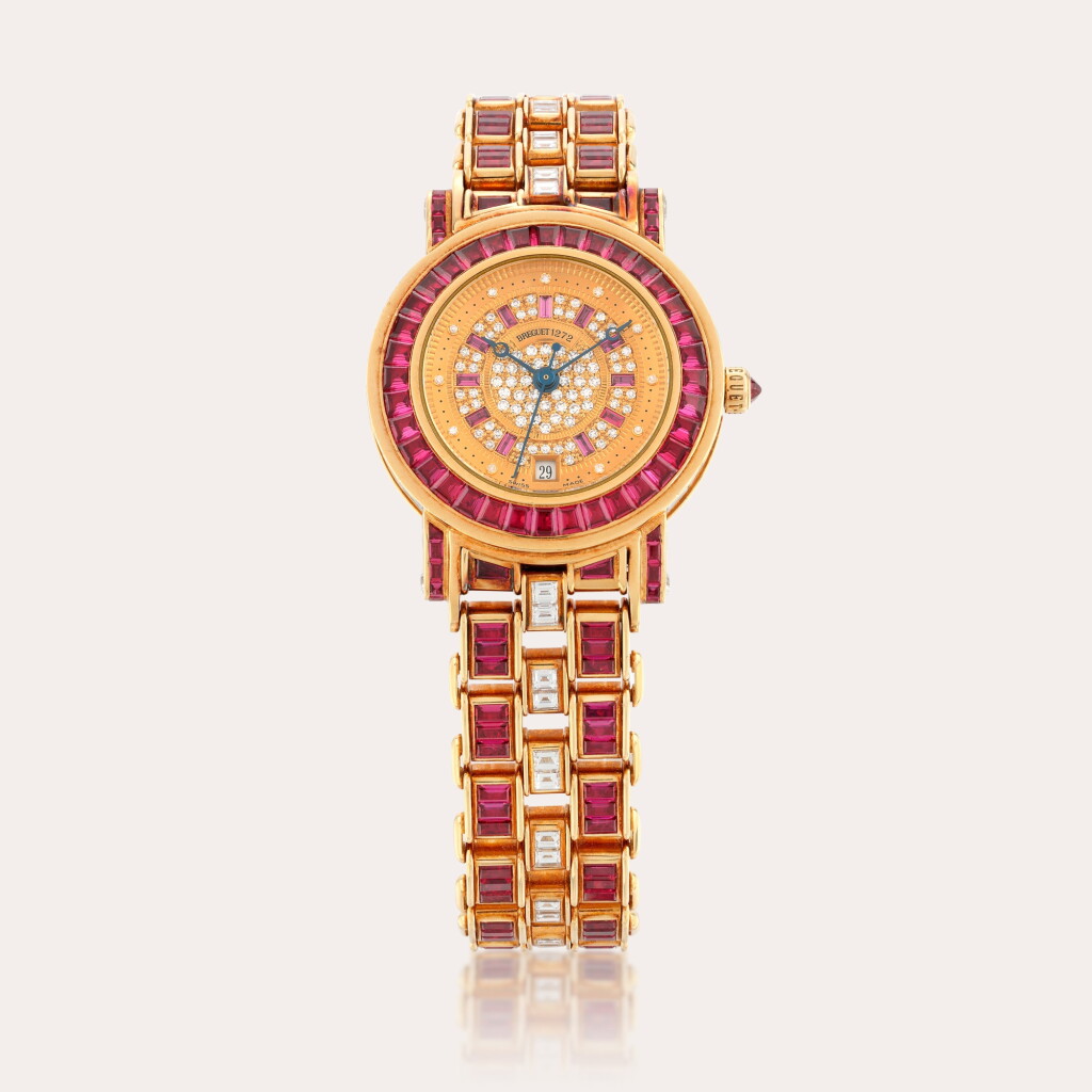 View full screen - View 1 of Lot 68. An impressive lady’s 18ct yellow gold, diamond and ruby-set bracelet watch with date.