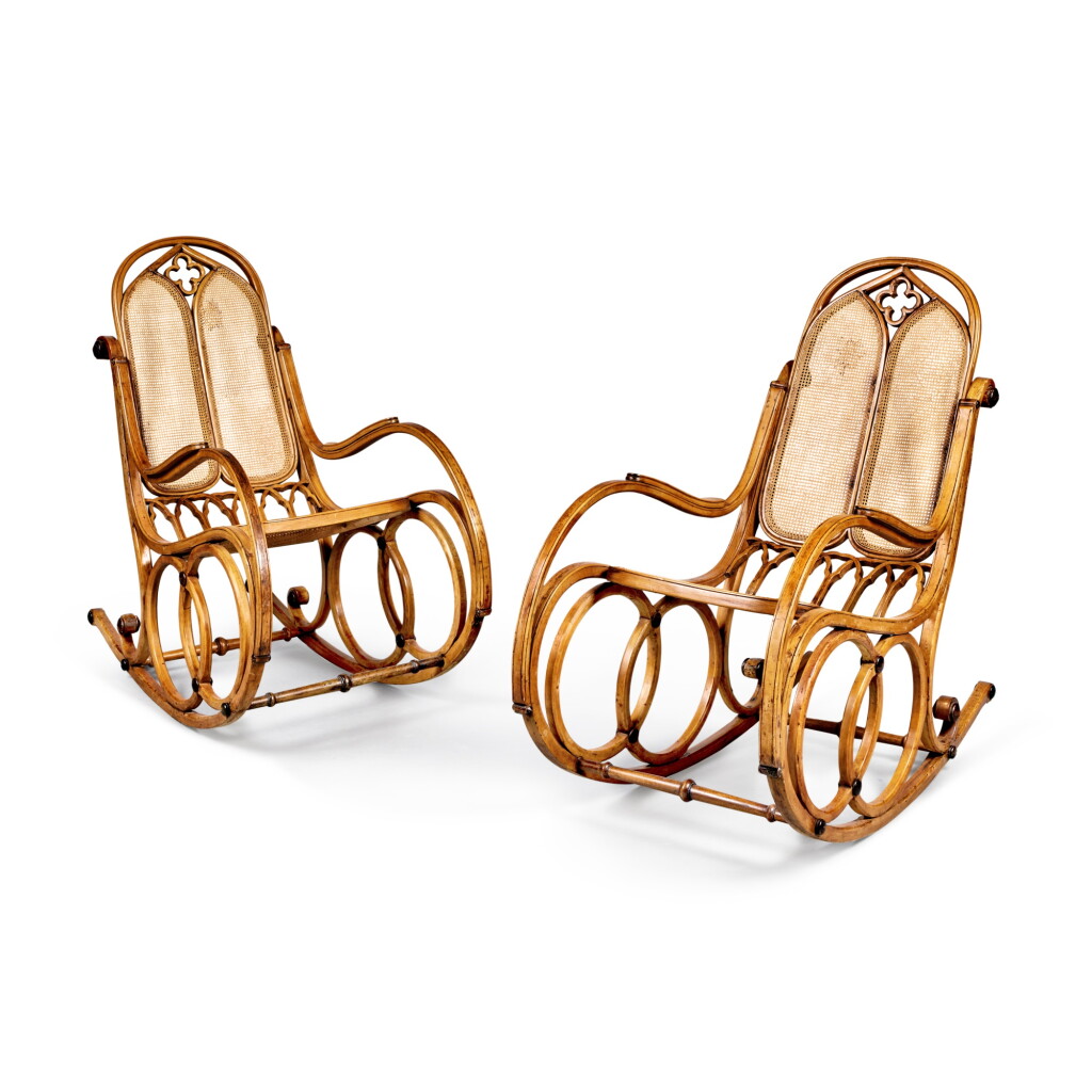 View full screen - View 1 of Lot 584. A Pair of Austrian Neogothic Ebonised and Beechwood Caned Seat Rocking Chairs, Mid-19th Century .