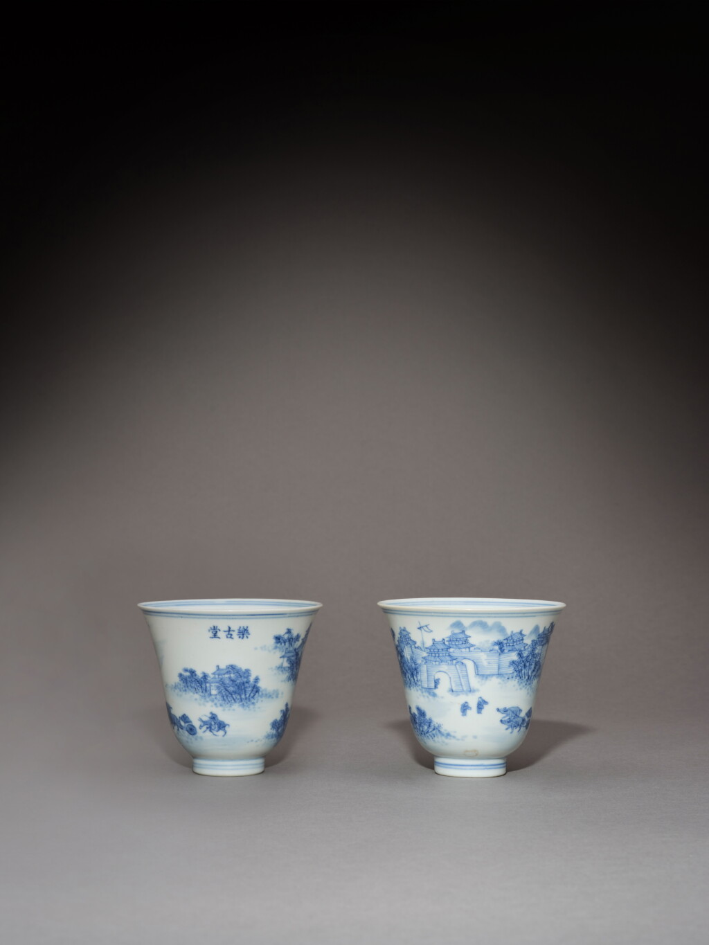 View full screen - View 1 of Lot 91. A rare pair of hall marked blue and white 'landscape' cups, Marks and period of Daoguang | 清道光 青花人物山水圖盃一對 《大清道光年製》《樂古堂》款.