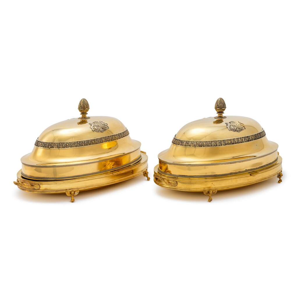 View full screen - View 1 of Lot 164. THE DEMIDOFF AND BORGHESE SERVICES: A Pair of Large French Silver-Gilt Dish Covers from the Demidoff Service, Maison Odiot, Paris, Circa 1819, with Associated Gilt Metal Warming Stands from the Borghese Service, Attributed to Biennais, Paris, Early 19th Century.