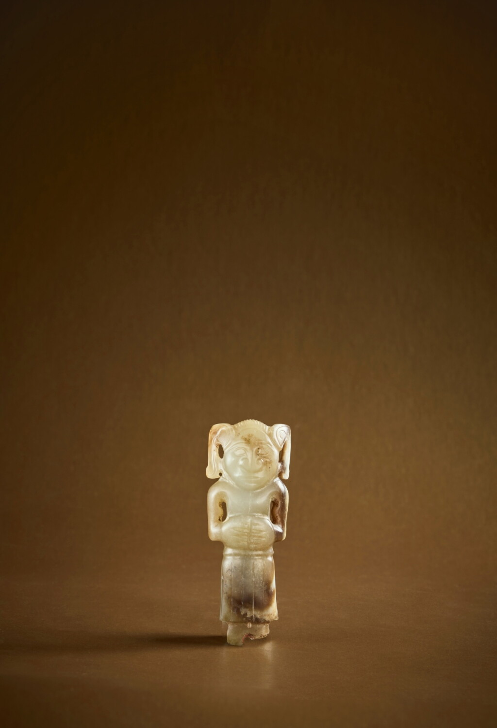 View full screen - View 1 of Lot 106. An extremely rare pale green and brown jade carving of a human, Western Zhou dynasty .