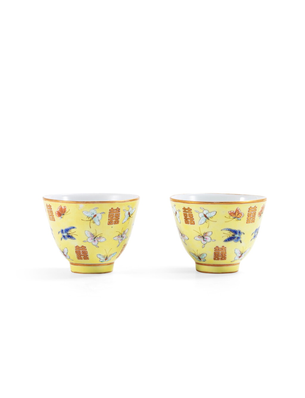 View full screen - View 1 of Lot 164. A pair of imperial lemon yellow-ground 'shuangxi and butterflies' wine cups Marks and period of Tongzhi | 清同治 黃地粉彩百蝶囍字紋盃兩件 《同治年製》款.