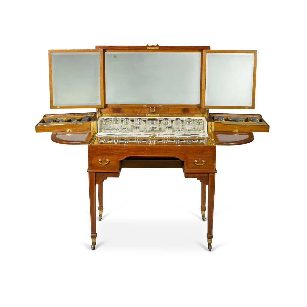 View full screen - View 1 of Lot 110. An Edwardian silver-mounted mahogany and boxwood-strung dressing table set, circa 1900, by Goldsmiths & Silversmiths Company.