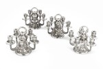 A set of four five-light silver candlesticks, Georg Jensen, Copenhagen, modern | Ensemble de quatre chandeliers à cinq lumières en argent par Georg Jensen, Copenhague, moderne