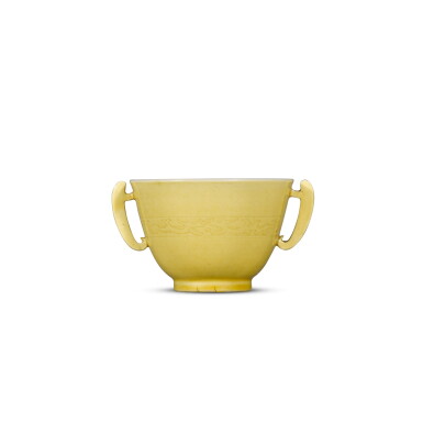 View full screen - View 1 of Lot 4. A yellow-glazed handled cup, Mark and period of Kangxi | 清康熙 黃釉暗刻龍紋耳盃 《大清康熙年製》款.