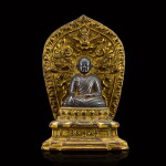 A rare silver figure of a lama and original gilt-copper throne Tibet, 13th - early 14th century | 十三至十四世紀初 西藏銀喇嘛坐像連鎏金銅原座