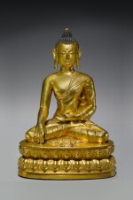 A GILT COPPER ALLOY FIGURE OF BUDDHA SHAKYAMUNI, TIBET, 15TH CENTURY