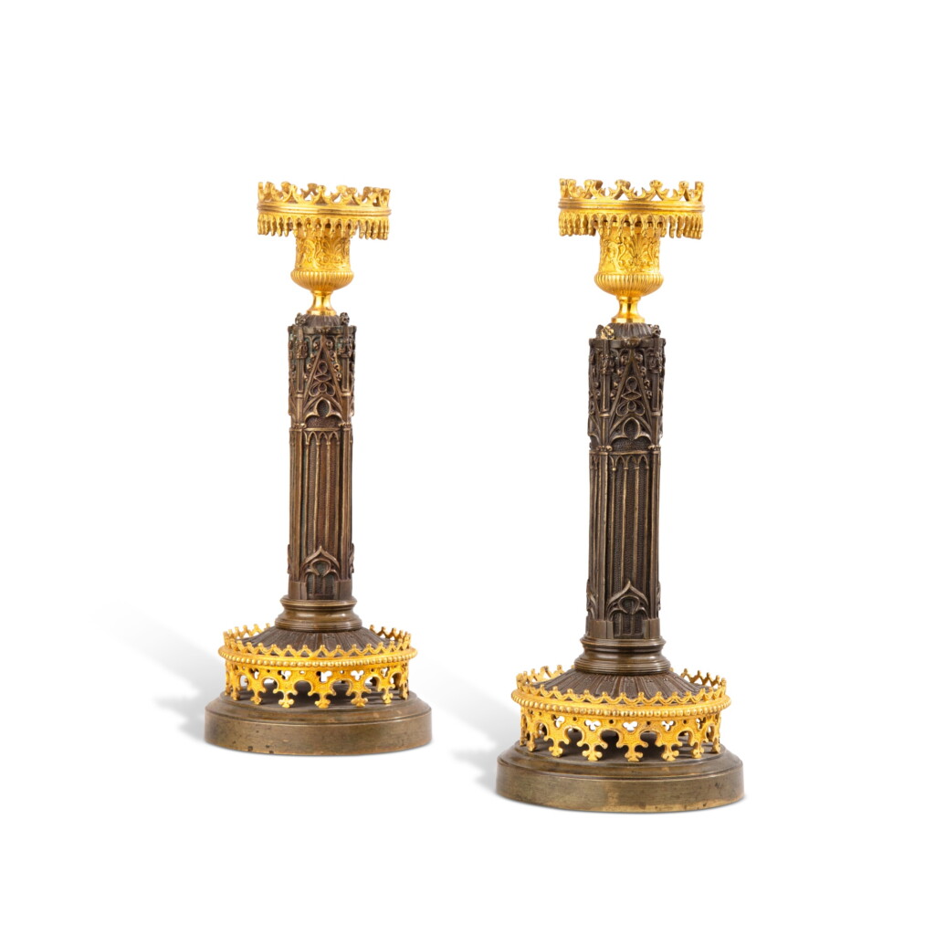View full screen - View 1 of Lot 618. A pair of neogothical gilt and patinated bronze candlesticks, mid-19th century | Paire de bougeoirs neogothiques en bronze doré et patiné, milieu du XIX siècle.