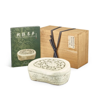 View full screen - View 1 of Lot 341. A Henan reverse carved 'peony' pillow, Northern Song dynasty 北宋 河南窰白地填黑地劃牡丹紋腰形枕.