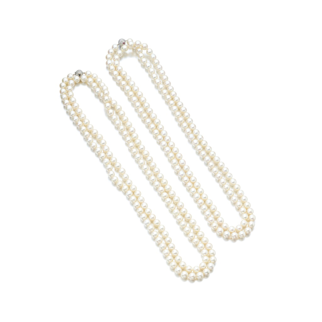 View full screen - View 1 of Lot 883. Pair of cultured pearl, ruby, sapphire and diamond sautoirs.