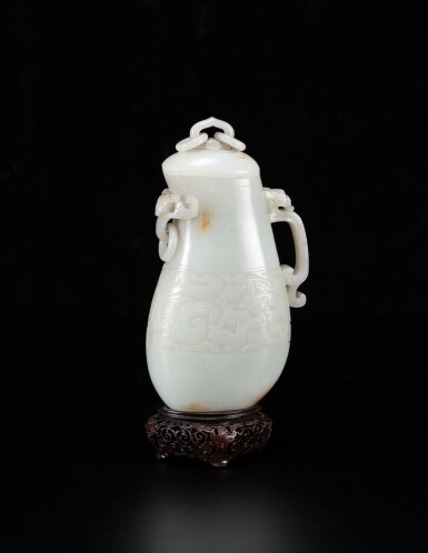 View full screen - View 1 of Lot 6. An exceptional white and russet jade archaistic ewer and cover Qing dynasty, Qianlong period | 清亁隆 白玉雕仿古鳳凰紋活環連蓋匜.