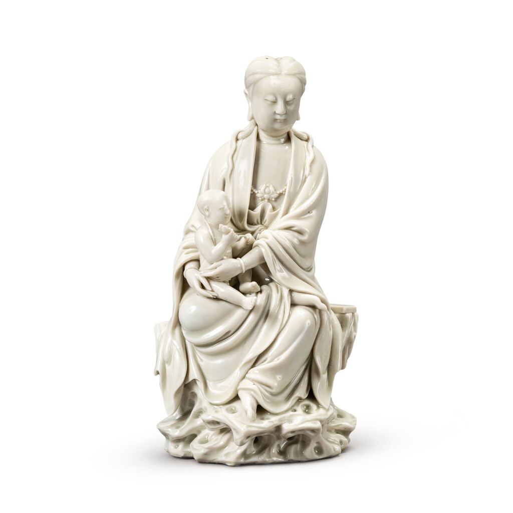View full screen - View 1 of Lot 138. A blanc de Chine figure of Guanyin and child, 17th-18th century | 十七至十八世紀 德化窰送子觀音坐像.