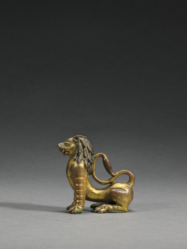 View full screen - View 1 of Lot 69. A gilt-copper alloy figure of a lion, Nepal, 15th/16th century | 尼泊爾 十五/十六世紀 鎏金銅合金臥獅.