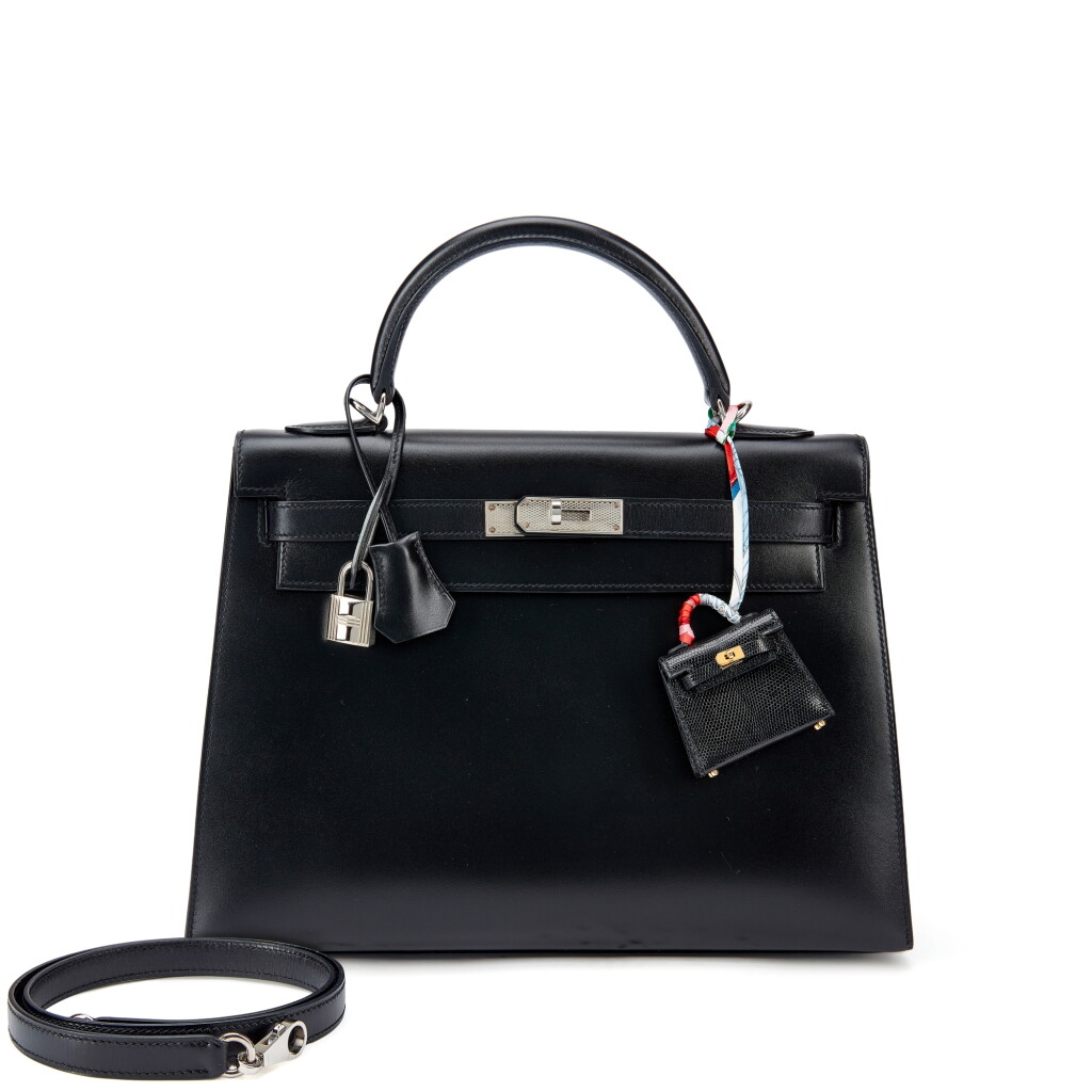 View full screen - View 1 of Lot 943. Set of Two Limited Edition Black Box Kelly 32 Sellier Guilloche Palladium Hardware, 2013 and Black Shiny Niloticus Lizard Micro Mini Twilly Kelly Bag Charm Gold Hardware, 2019.