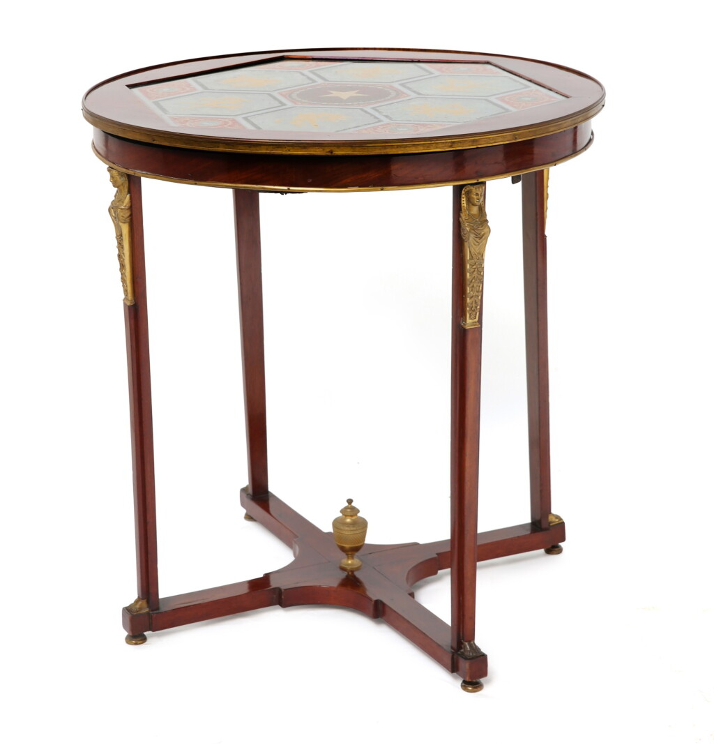 View full screen - View 1 of Lot 122. A RUSSIAN MAHOGANY REVERSE PAINTED GLASS GUÉRIDON, EARLY 19TH CENTURY | GUÉRIDON EN ACAJOU À PLATEAU EN VERRE ÉGLOMISÉ, TRAVAIL RUSSE DU DÉBUT DU XIXE SIÈCLE.