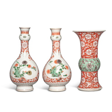 View full screen - View 1 of Lot 1190. A pair of iron-red-ground famille-verte 'butterfly and floral' garlic-neck bottle vases and a 'floral' beaker vase, Qing dynasty, Kangxi period | 清康熙 五彩蝶戀花圖蒜頭瓶一對及花觚.