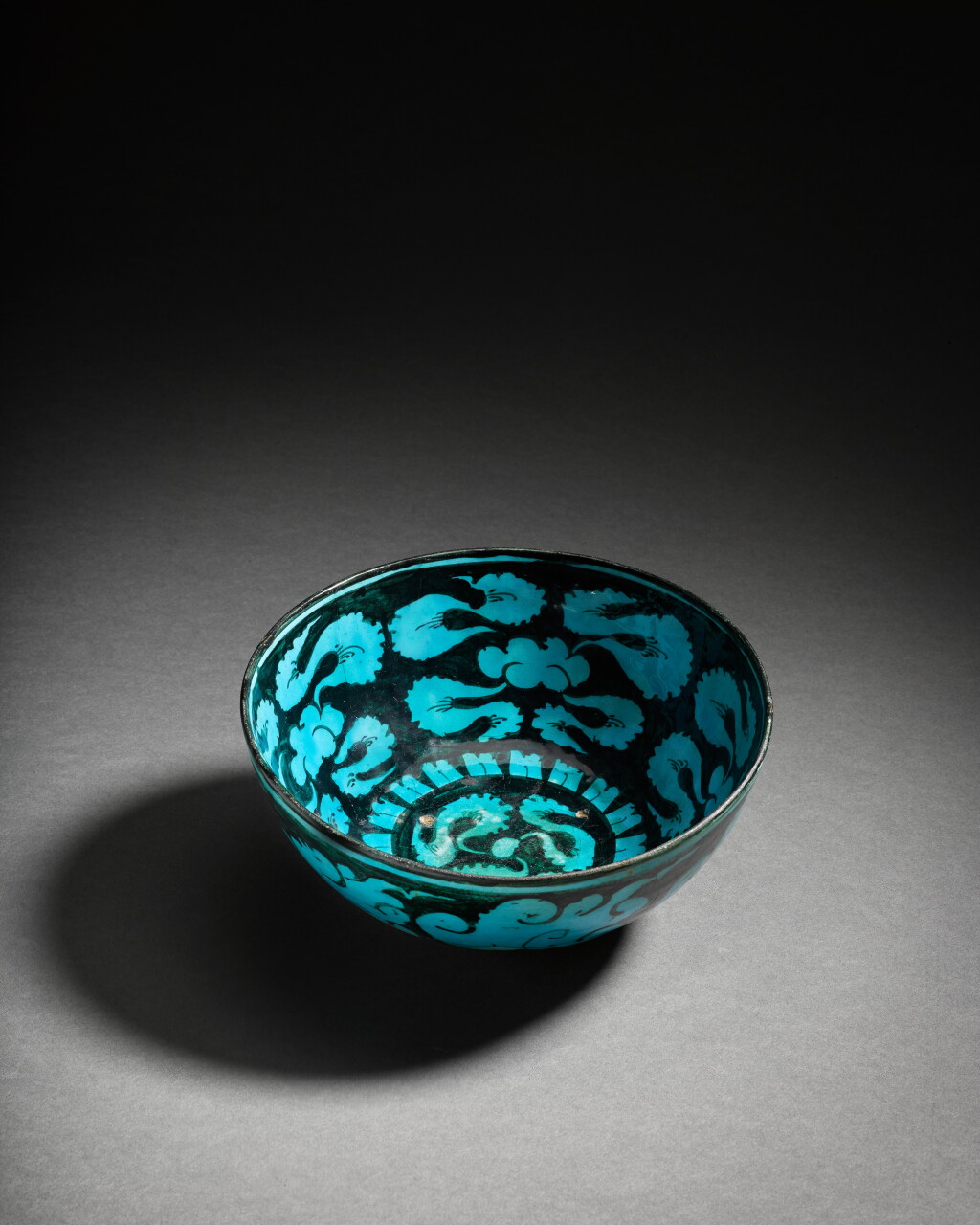 View full screen - View 1 of Lot 65. A Timurid turquoise pottery bowl with cloud bands, Persia, 15th century.