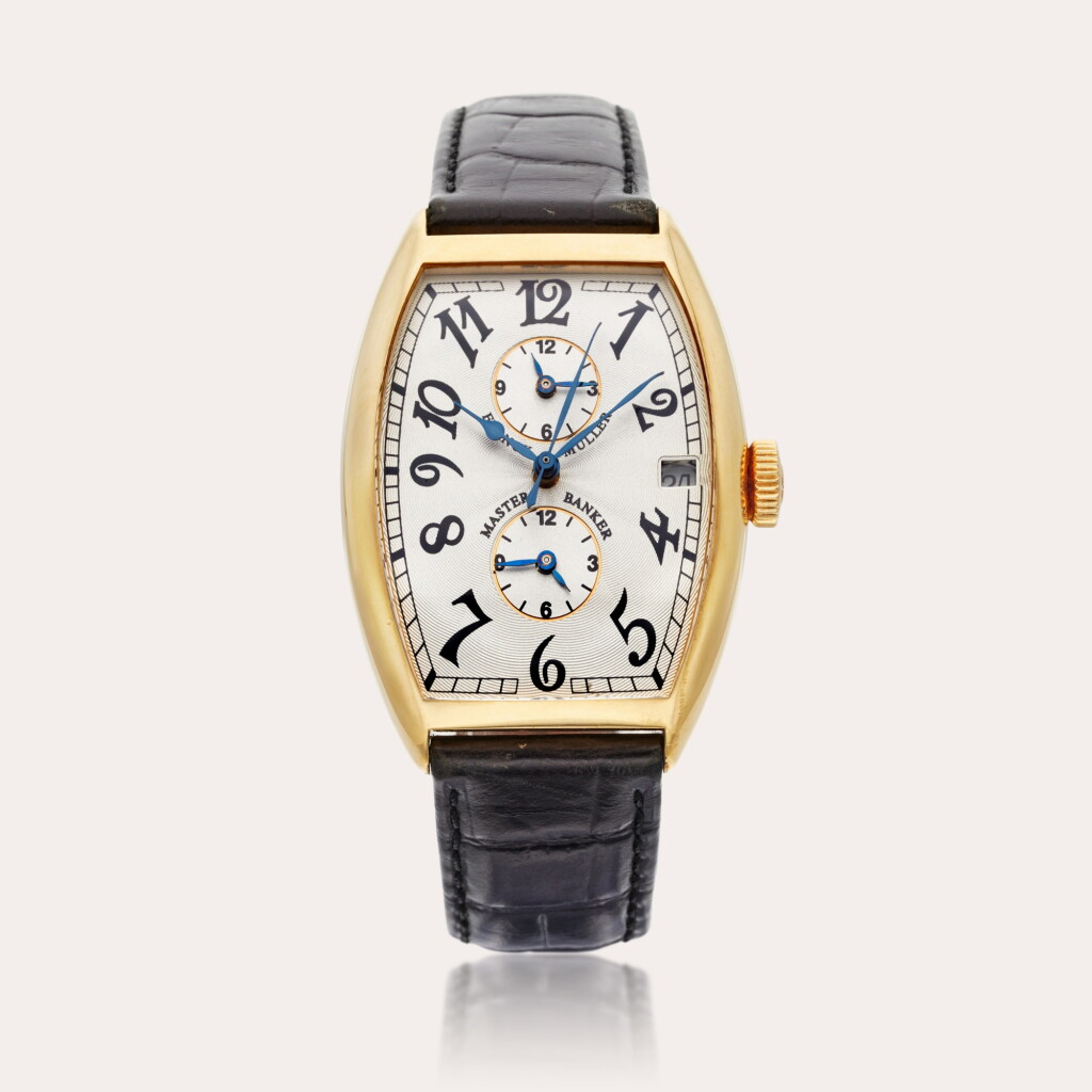 View full screen - View 1 of Lot 447. Reference 5850 Master Banker | A yellow gold tonneau-shaped triple time zone automatic wristwatch with date, Circa 2000.