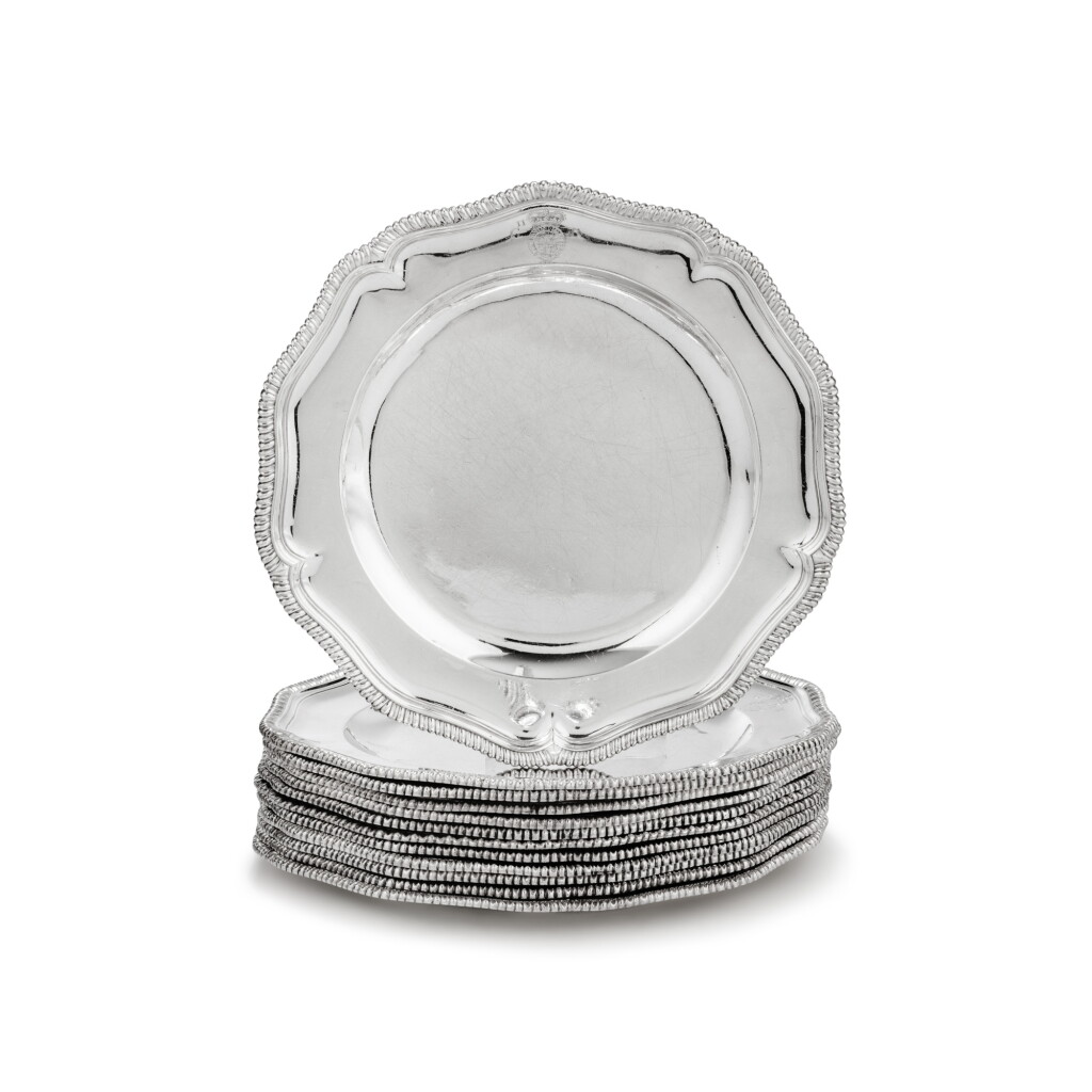 View full screen - View 1 of Lot 167. A silver set of 12 royal dinner plates, ten George II apparently unmarked, circa 1740, two by Frederick Kandler, London, 1752 | Ensemble en argent de 12 assiettes de table royales, dix apparemment non poinçonnées, vers 1740, deux par Frederick Kandler, Londres, 1752.