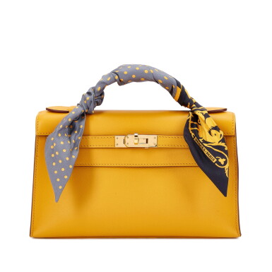 View full screen - View 1 of Lot 6068. Jaune Ambre Swift Kelly Pochette Gold Hardware, 2018 and Twilly.