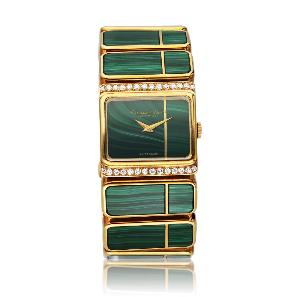 View full screen - View 1 of Lot 243. Reference 7152 'Khanjar' | A yellow gold, malachite and diamond-set bracelet watch with a matching pair of ear clips, pendant with chain, and ring, Circa 1970.