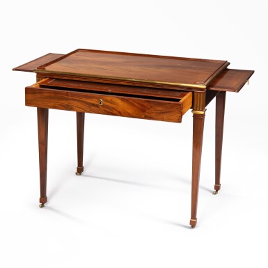 View full screen - View 1 of Lot 35. A Louis XVI flamed mahogany and gilt-bronze writing table, circa 1785, attributed to David Roentgen | Table à écrire en acajou flammé et bronze doré d'époque Louis XVI, vers 1785, attribuée à David Roentgen .