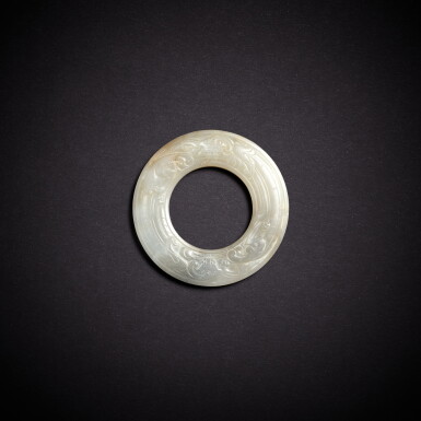 View full screen - View 1 of Lot 5665. A white jade 'chilong' disc, huan, Southern Song dynasty | 南宋 白玉螭龍紋環.