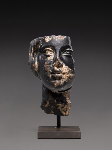 View full screen - View 1 of Lot 156. A Fragmentary Roman Basalt Head of a Woman or Goddess, circa 2nd Century A.D..